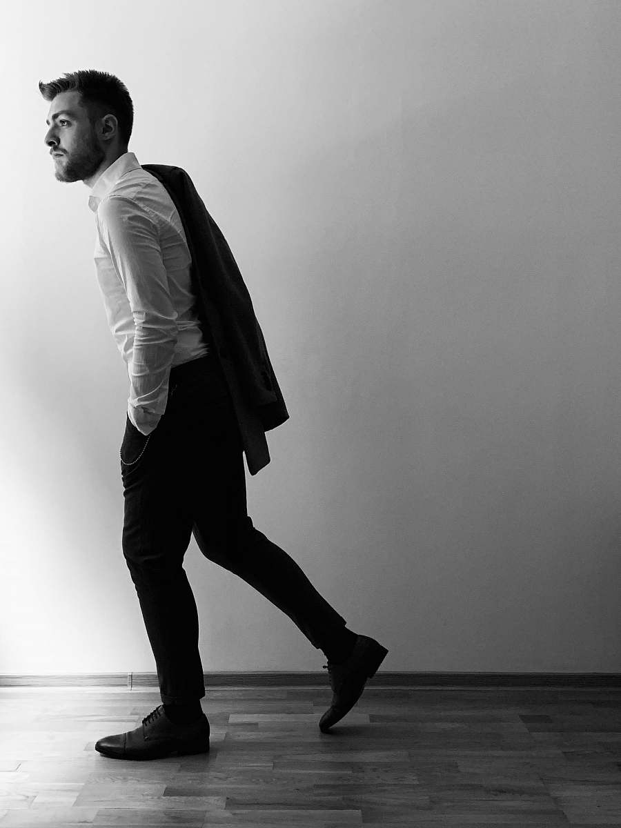 apparel man walking beside wall clothing