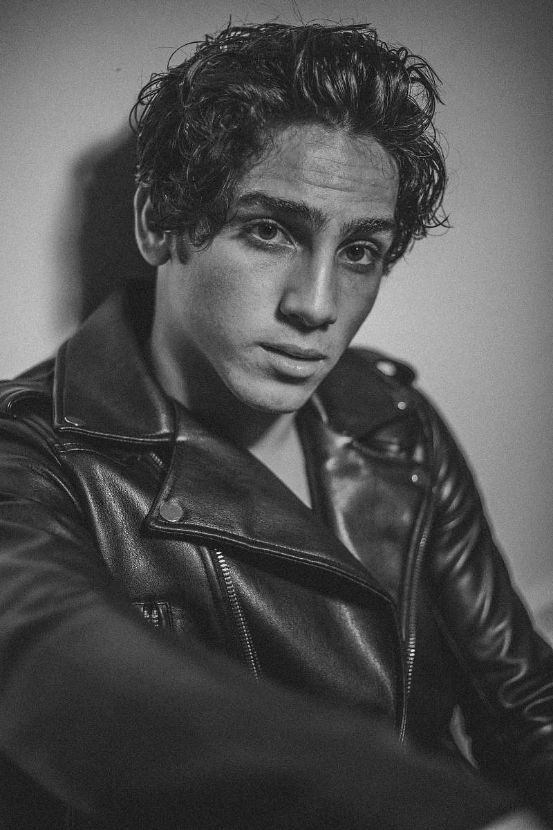 clothing man wearing jacket leaning on wall apparel