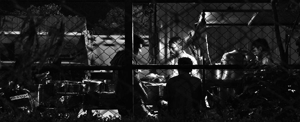 human people talking behind fence person