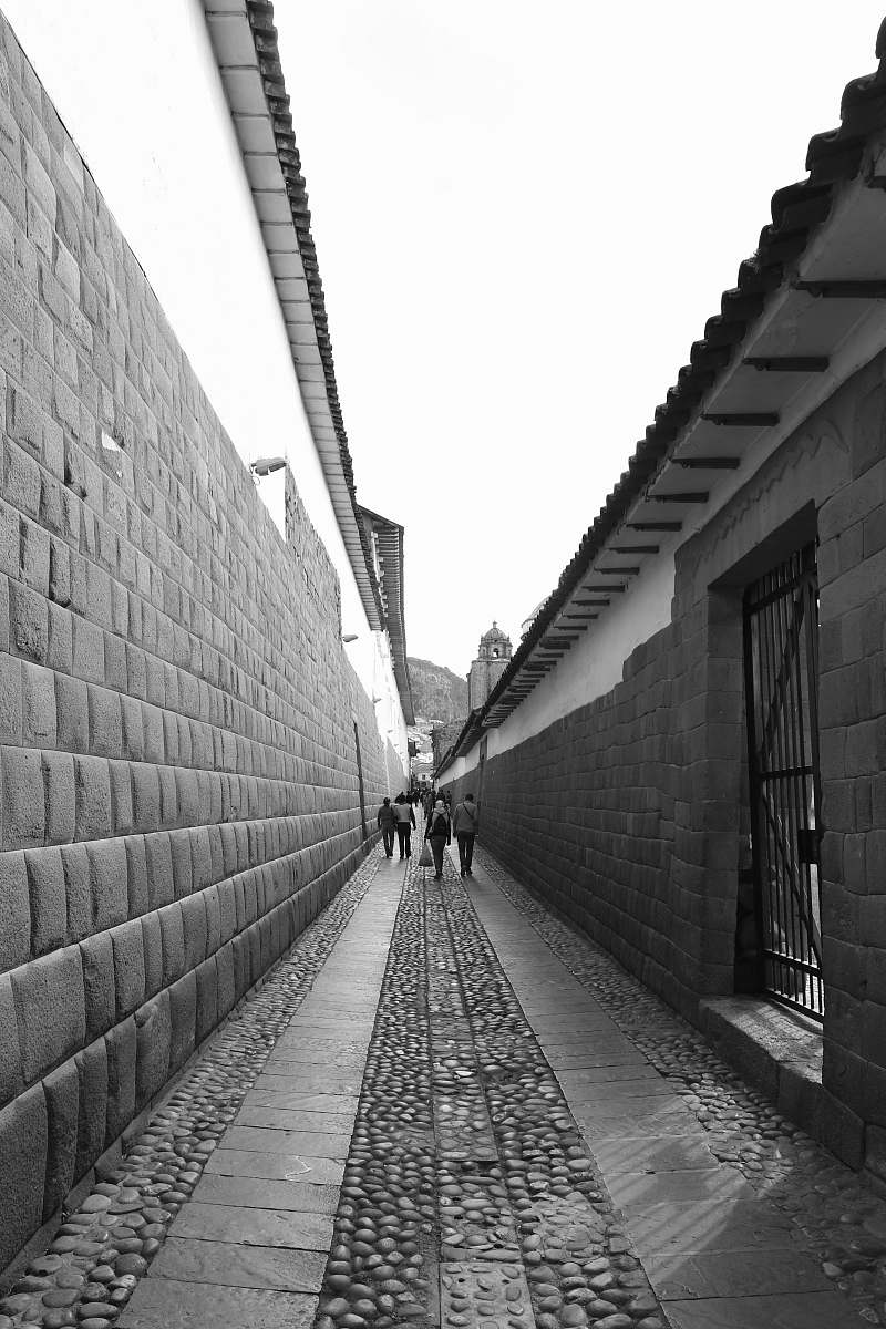 road people walks near concrete wall street