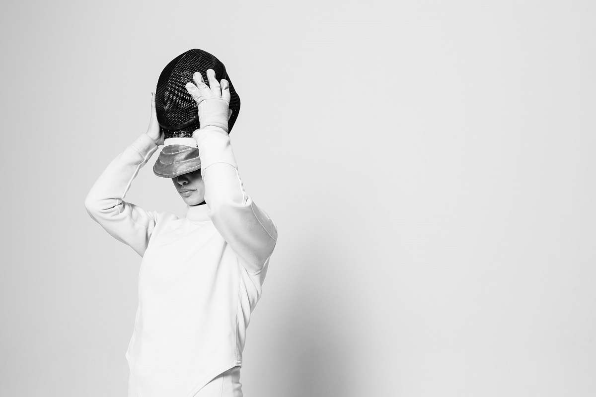 clothing person holding black cap apparel