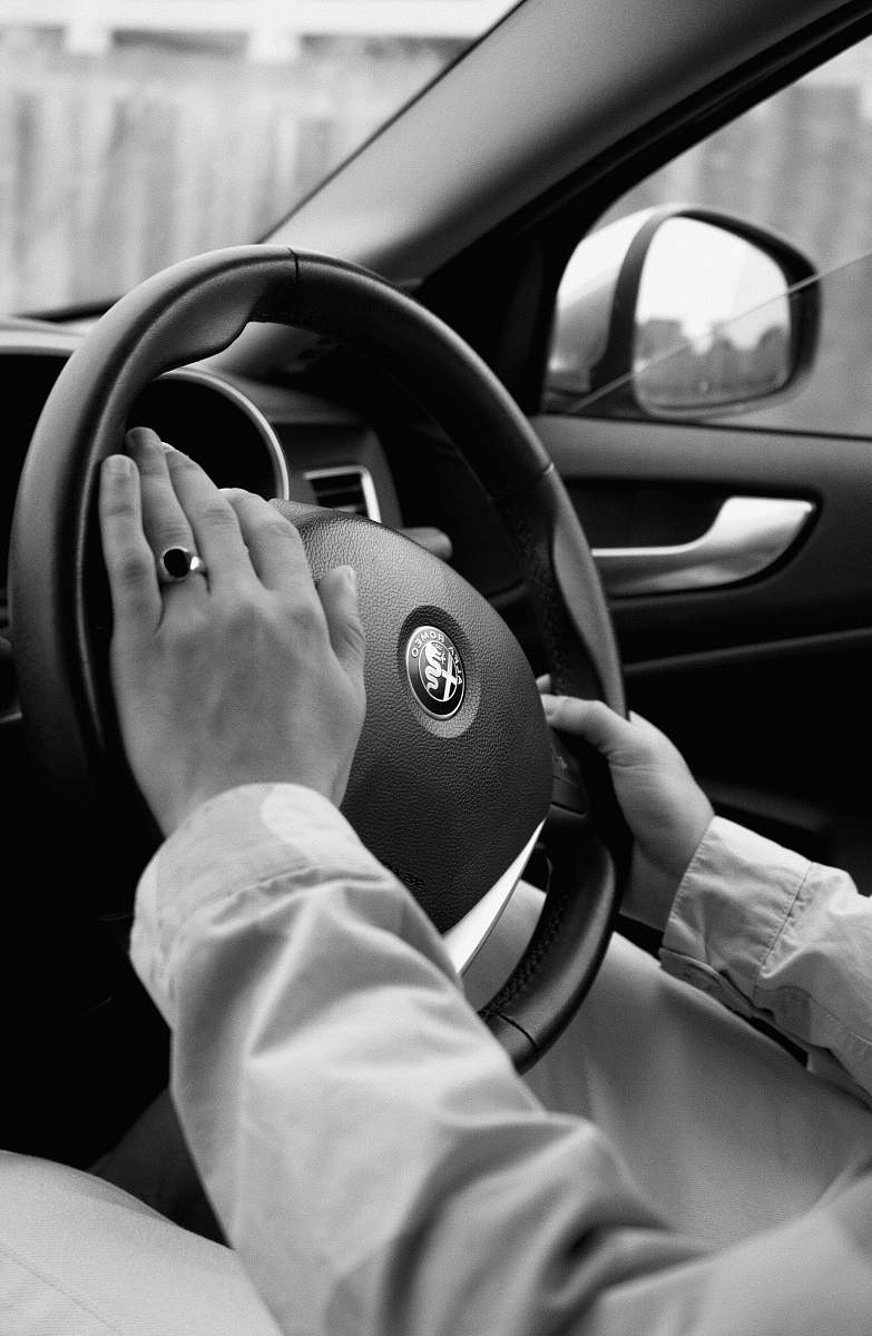 human person holding steering wheel car