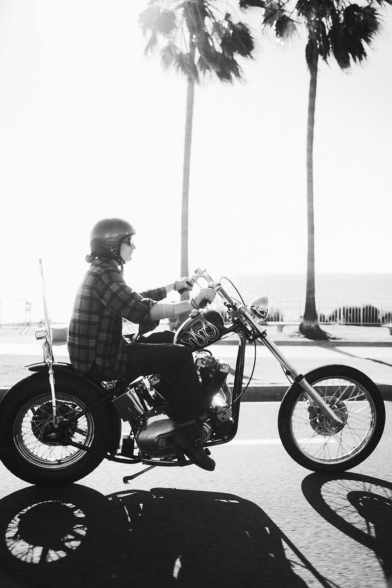 machine person riding on chopper motorcycle during daytime wheel