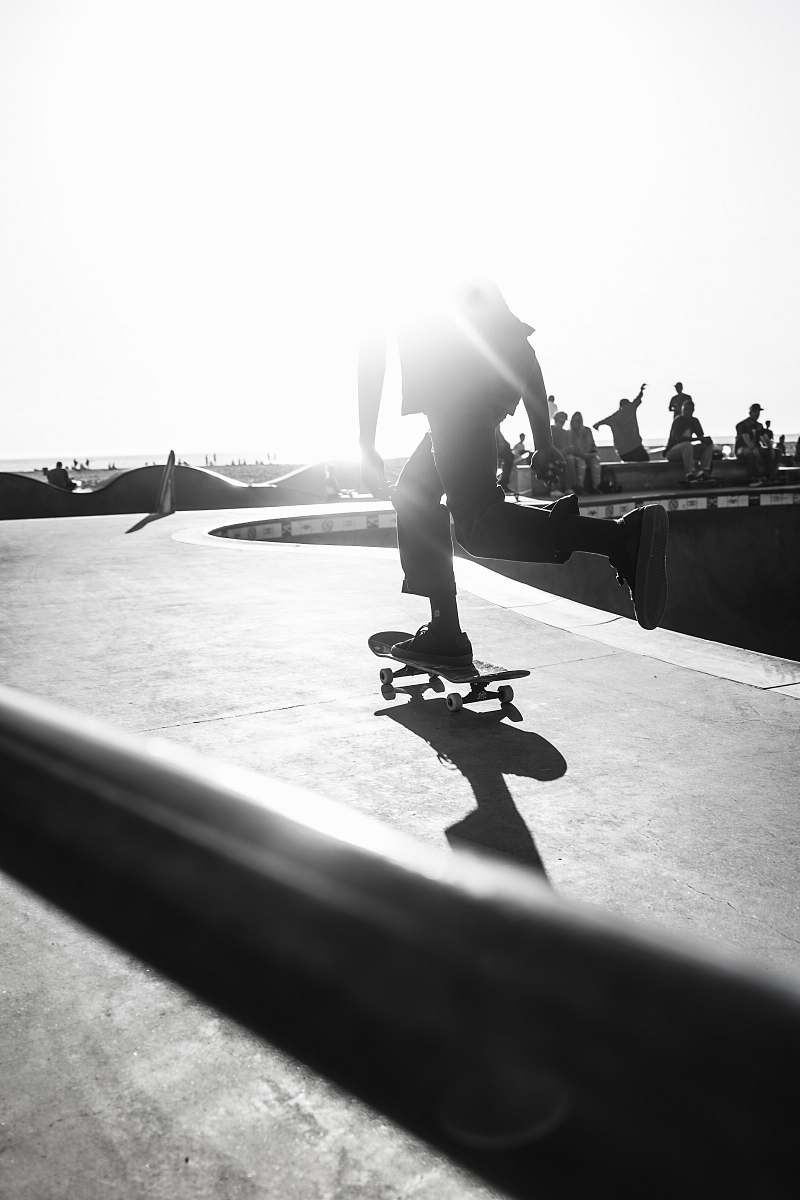 human person riding skateboard on grayscale photography person