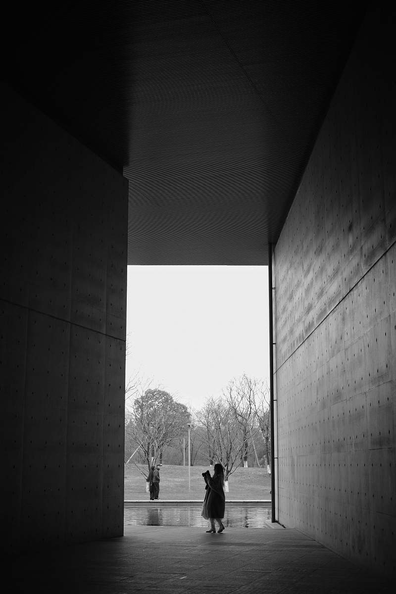 human person standing in between building person
