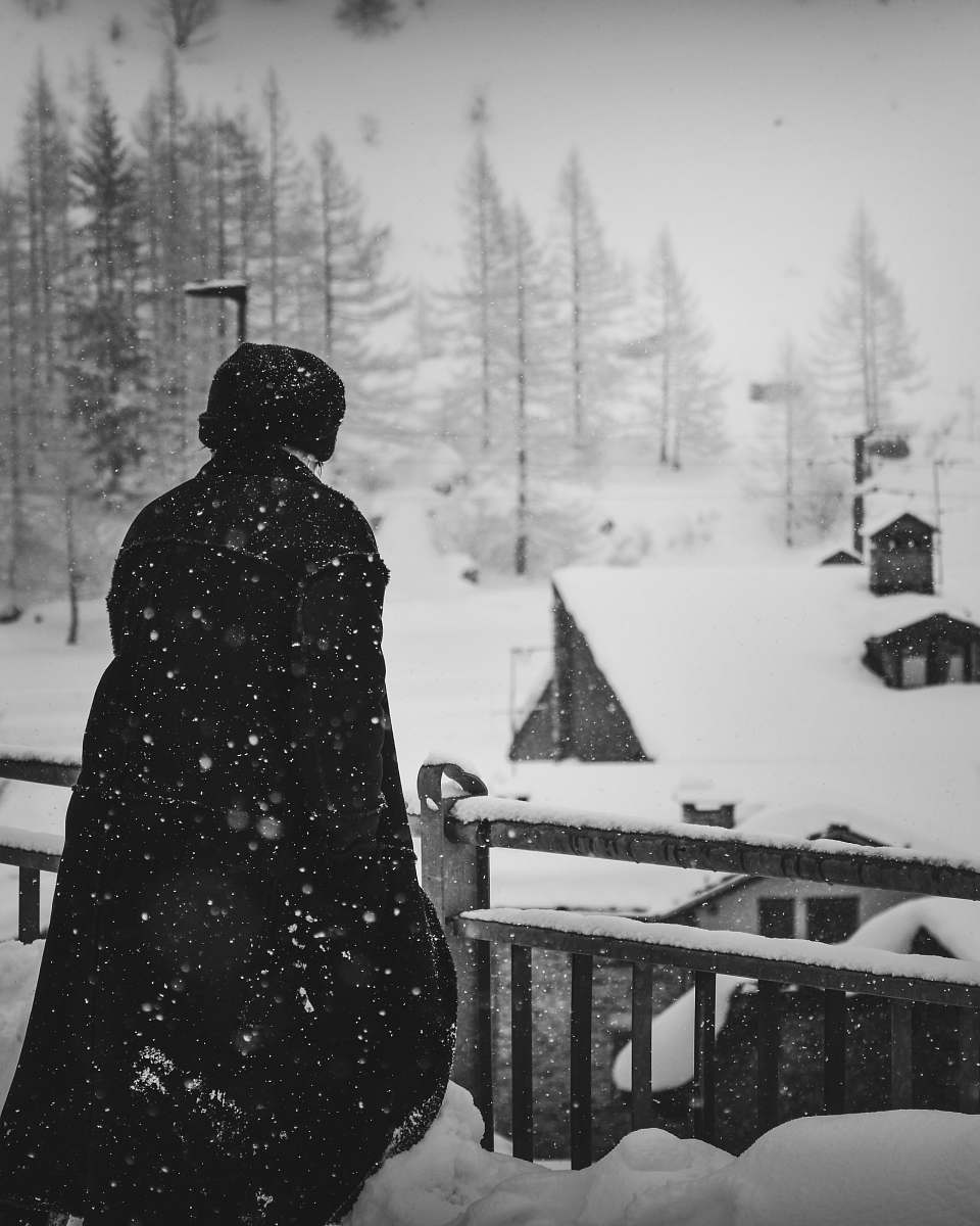 person person standing near snow coated houses snow