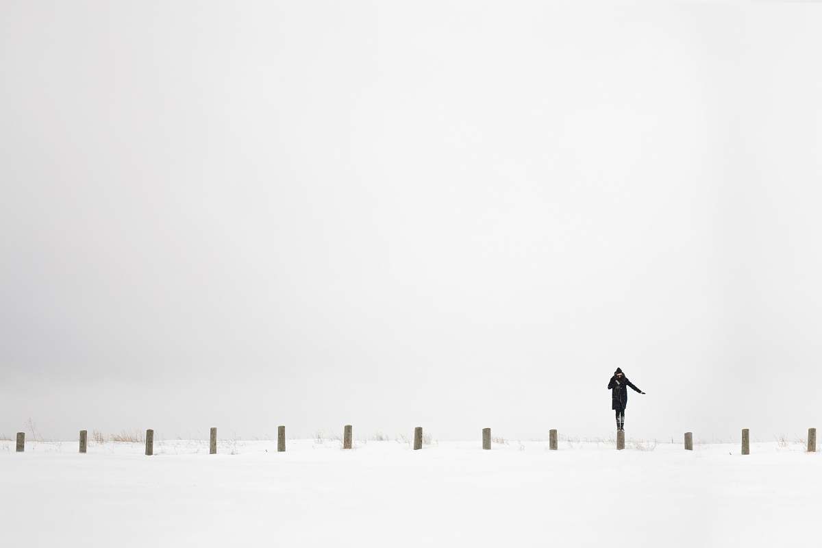 snow person standing on post canada