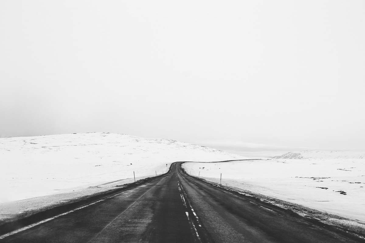 snow photo of asphalt road towards snow field road