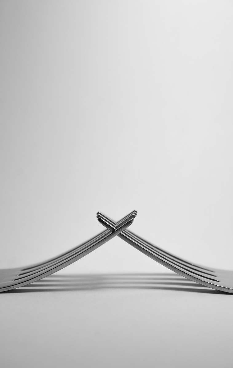 grey photo of stainless steel forks in white background cutlery