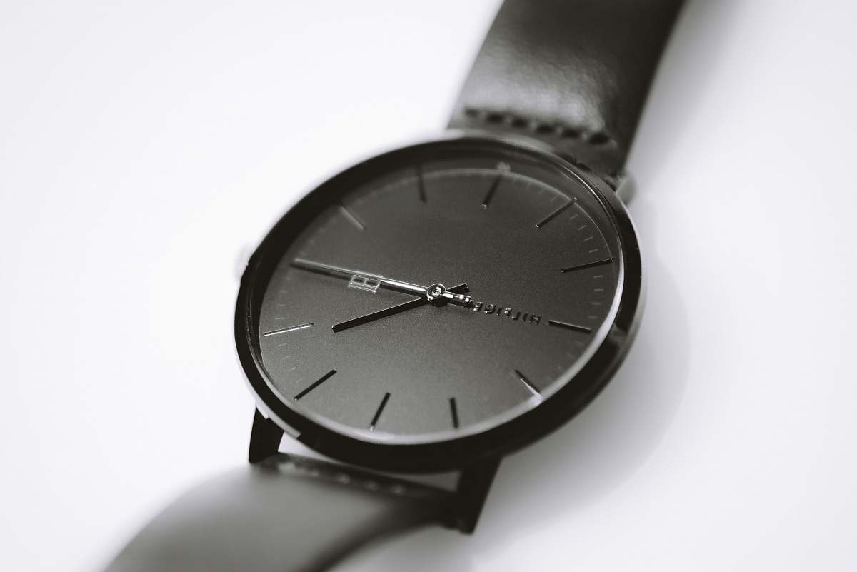 grey round black analog watch wristwatch