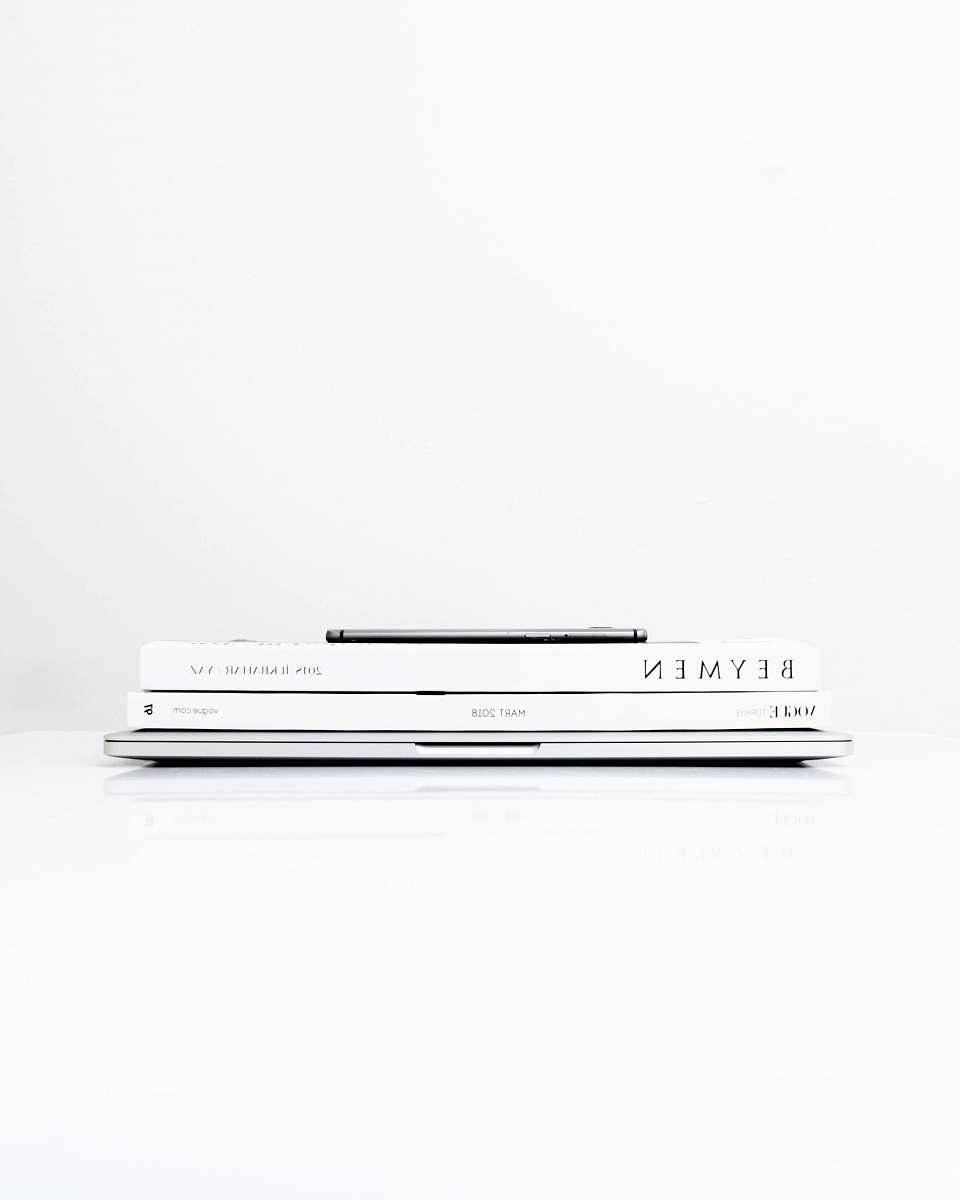 white silver laptop computer with two books on the top turkey