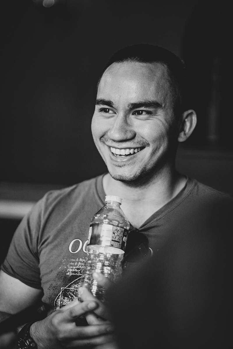 human smiling man holding clear bottled water people