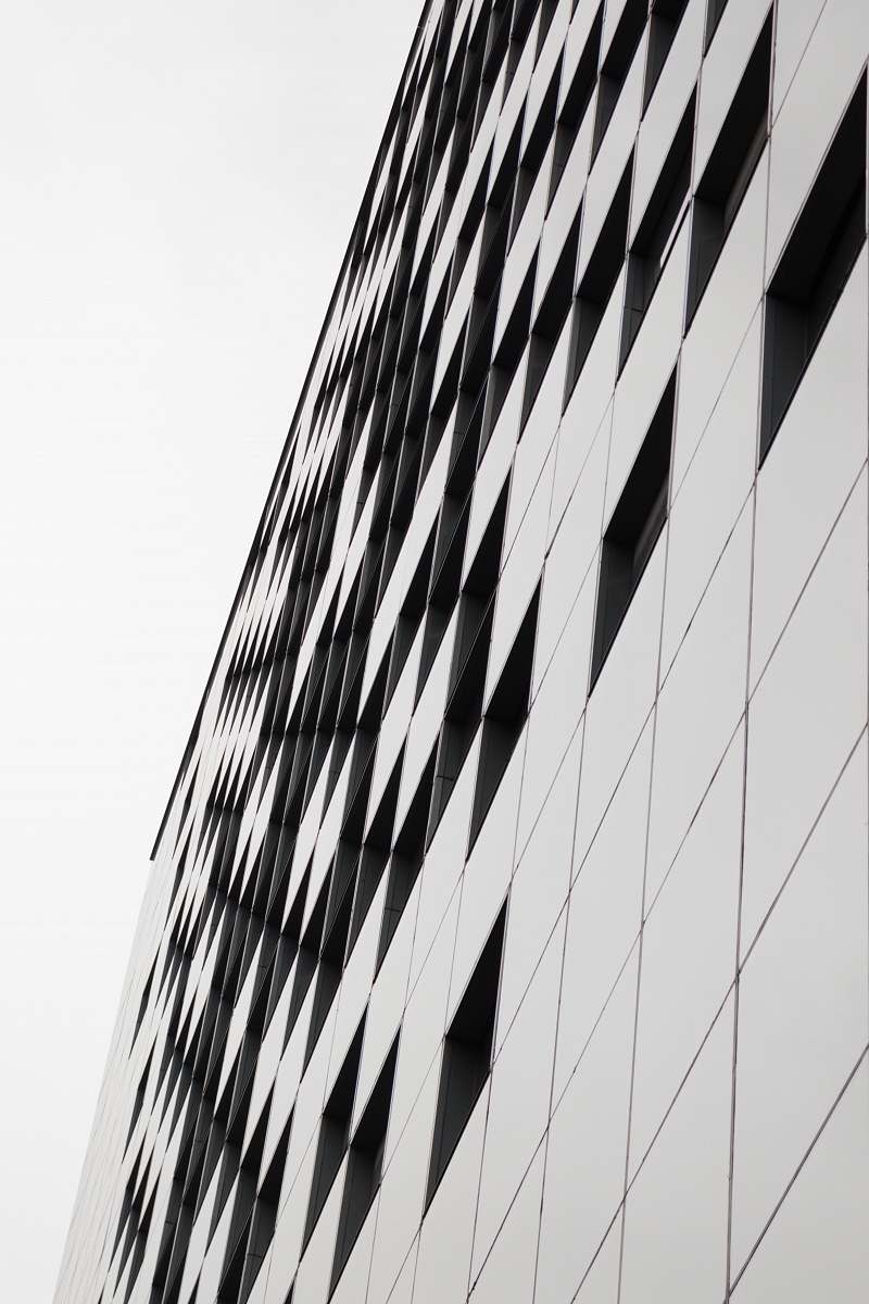 building tilt shot of gray and black building under daylight office building
