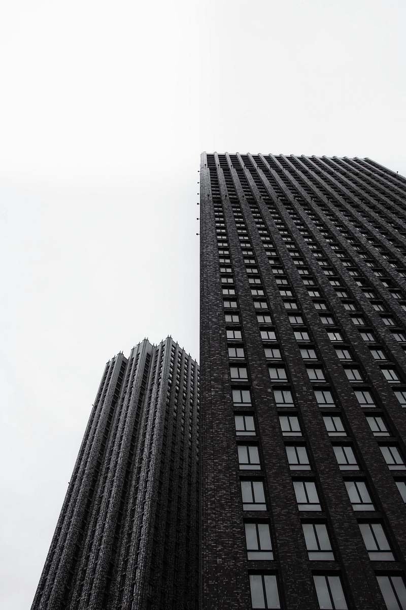 building two black high-rise buildings city