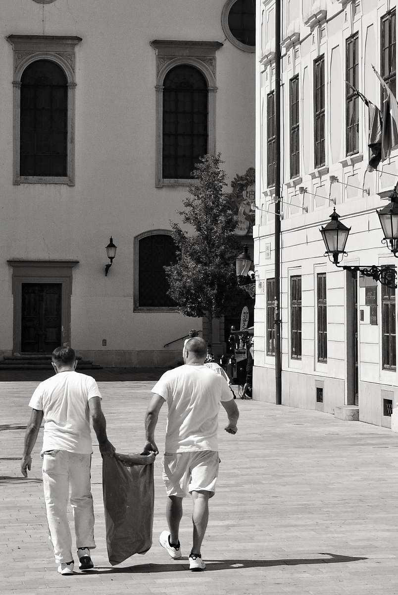 human two men carrying sack person