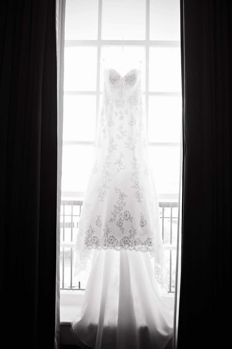 white white floral wedding gown beside window wedding