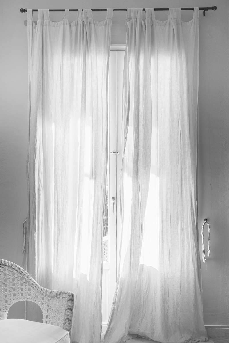 chair white window curtain hanging on black steel rod curtain