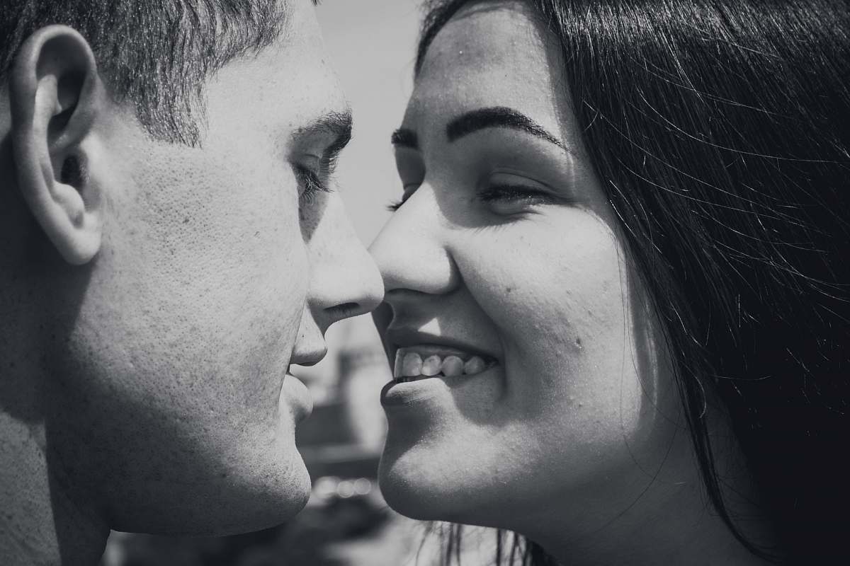 human woman and man facing each other while smiling person