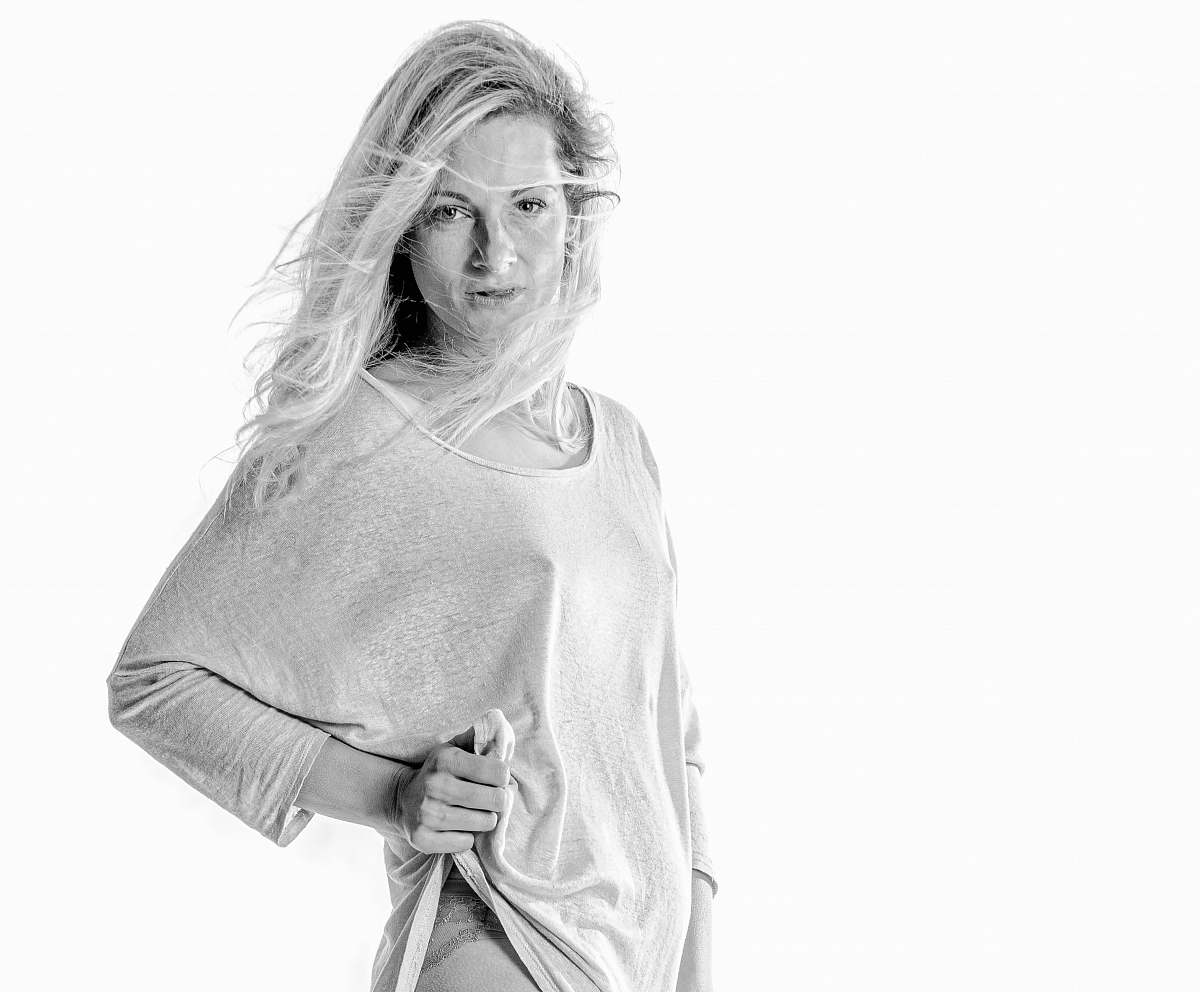 apparel woman lifting her shirt with her left hand clothing