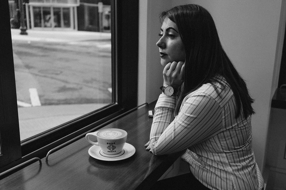 person woman sitting beside table human