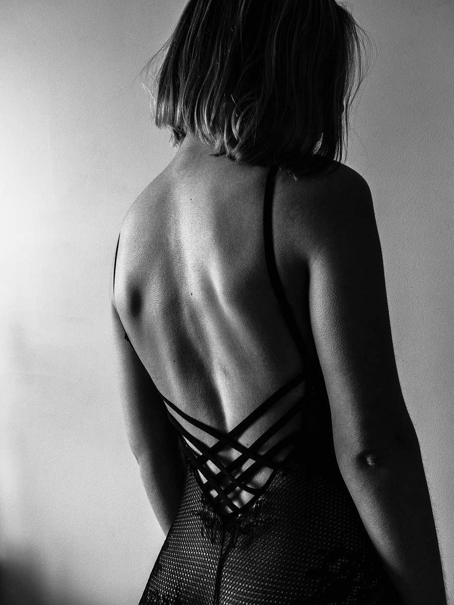 person woman standing against the wall back