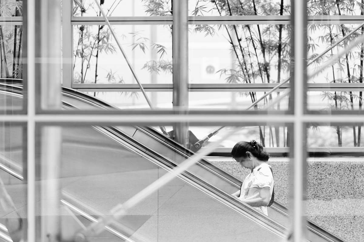 person woman standing on escalator human