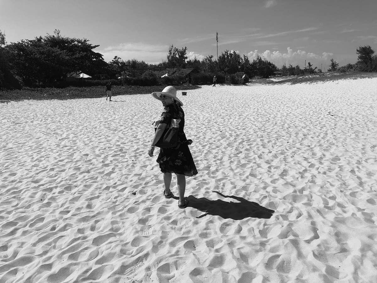nature women wearing a summer hat in a sandy land grey-scale photography outdoors