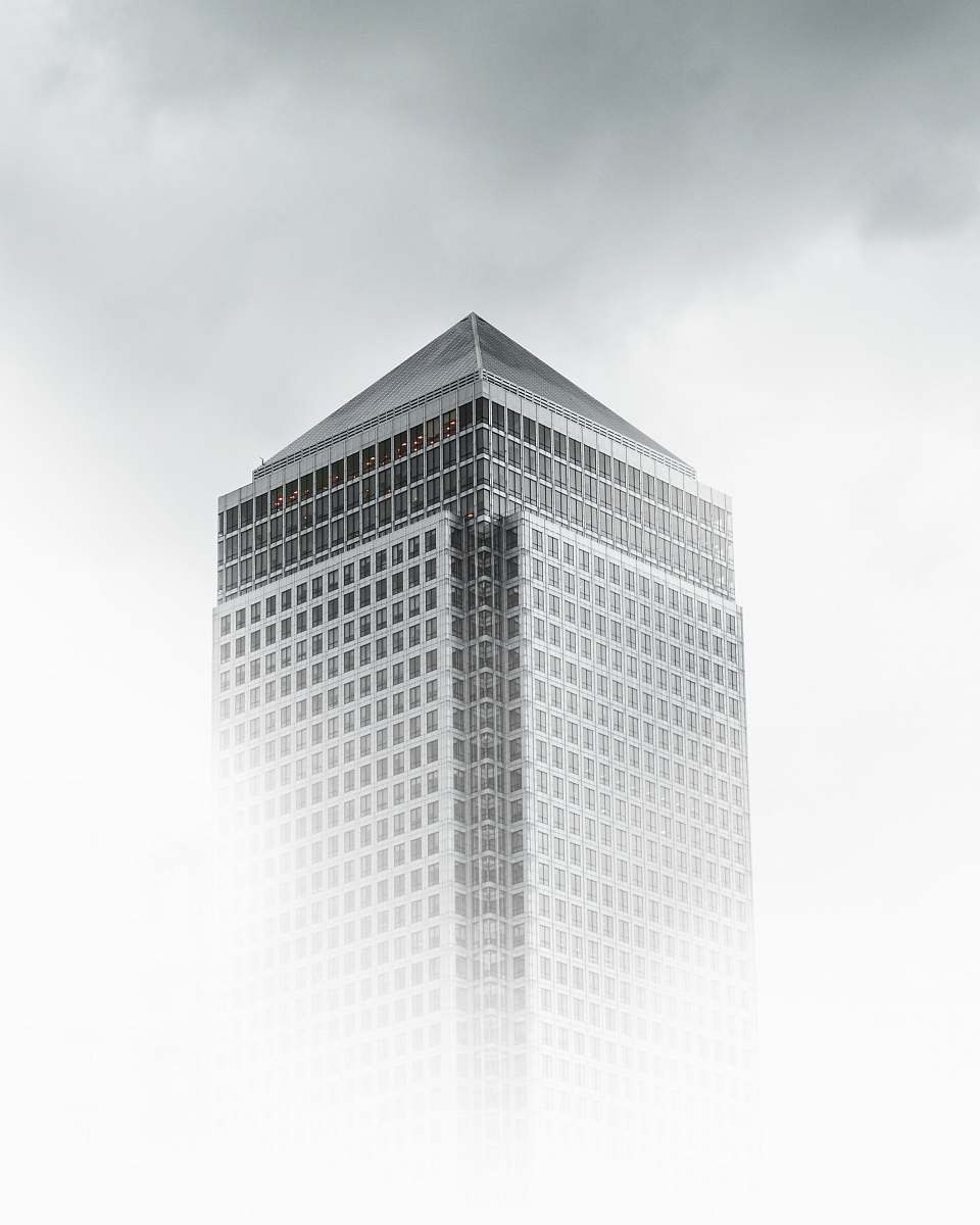 grey worm's-eye view photography of white and gray concrete building under cloudy sky architecture