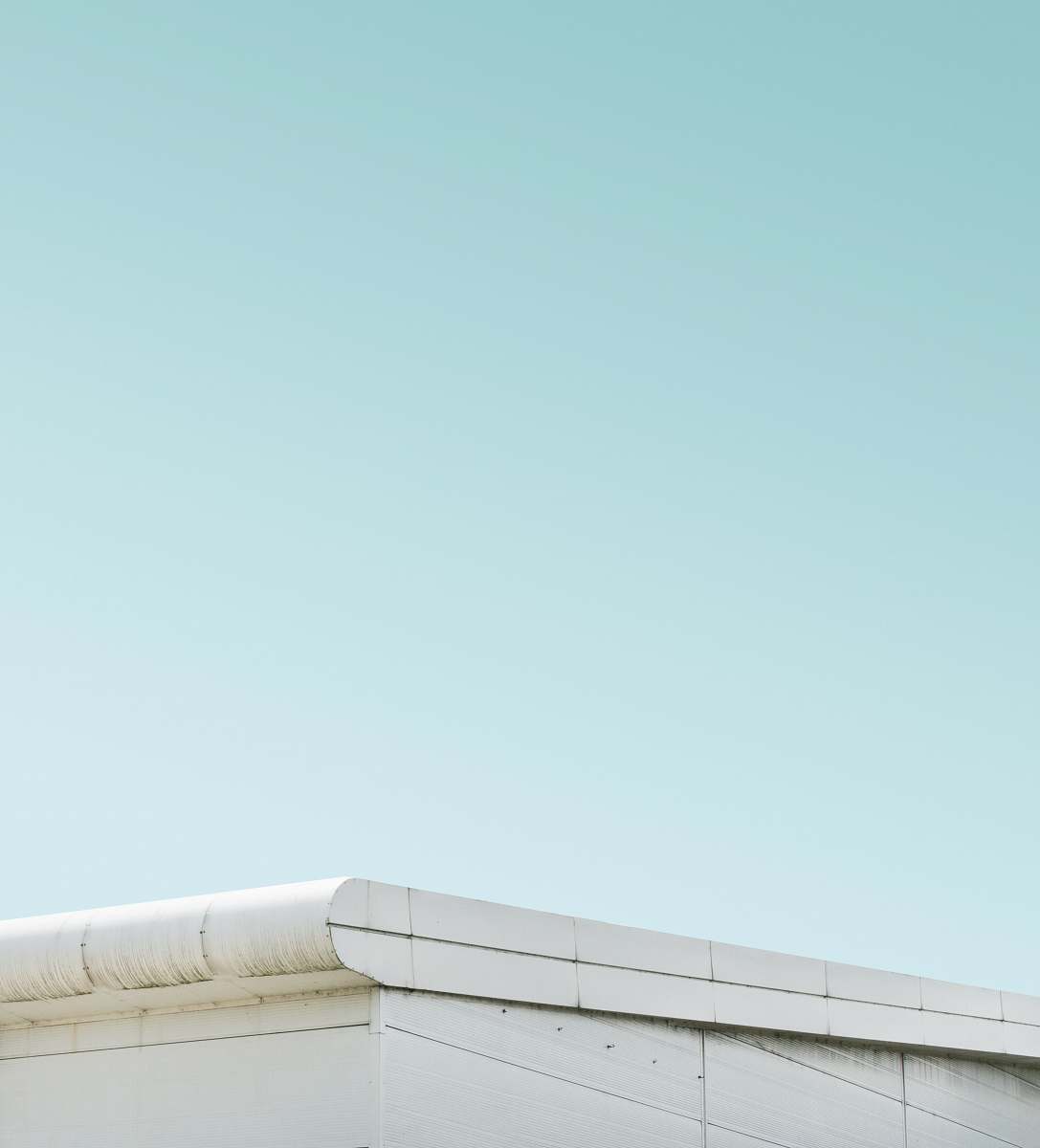 slough architectural photography of white steel roof structure sky