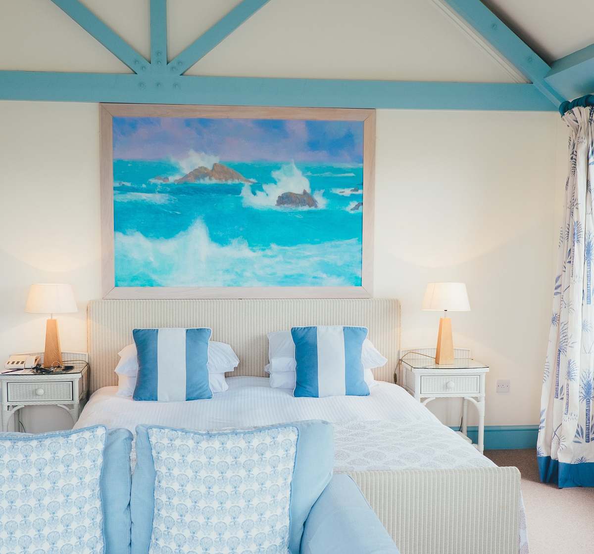 bedroom white and blue pillows beside brown table lamp indoors