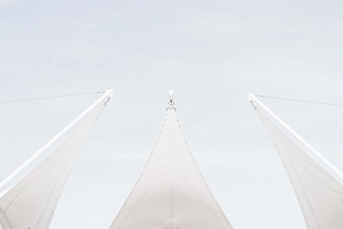 Immerse yourself in this stunning worm's eye view photography showcasing a collection of sailboats gracefully gliding on tranquil waters. The unique perspective captures the grandeur of their sails as they catch the gentle breeze, creating a mesmerizing scene perfect for maritime enthusiasts, travel blogs, or any creative project seeking to evoke a sense of adventure and the beauty of sailing. The vibrant colors of the sails against the backdrop of a serene sunset add an extraordinary touch, making it an ideal visual for brochures, websites, or social media.