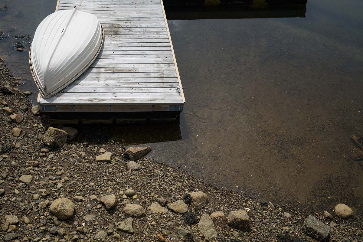 dinghy white boat on gray dock watercraft