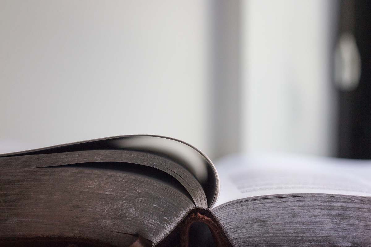 bible selective focus photo of an opened book grey