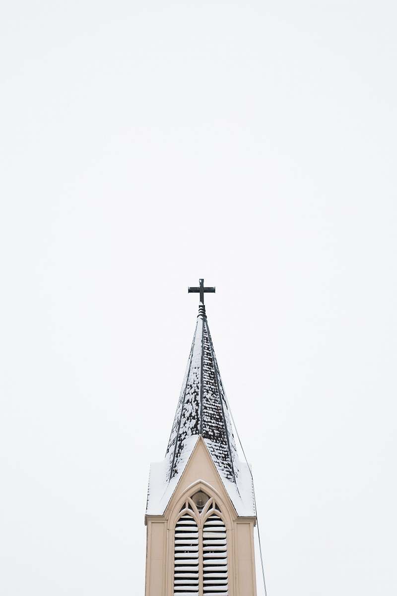 architecture beige and white church tower with cross spire