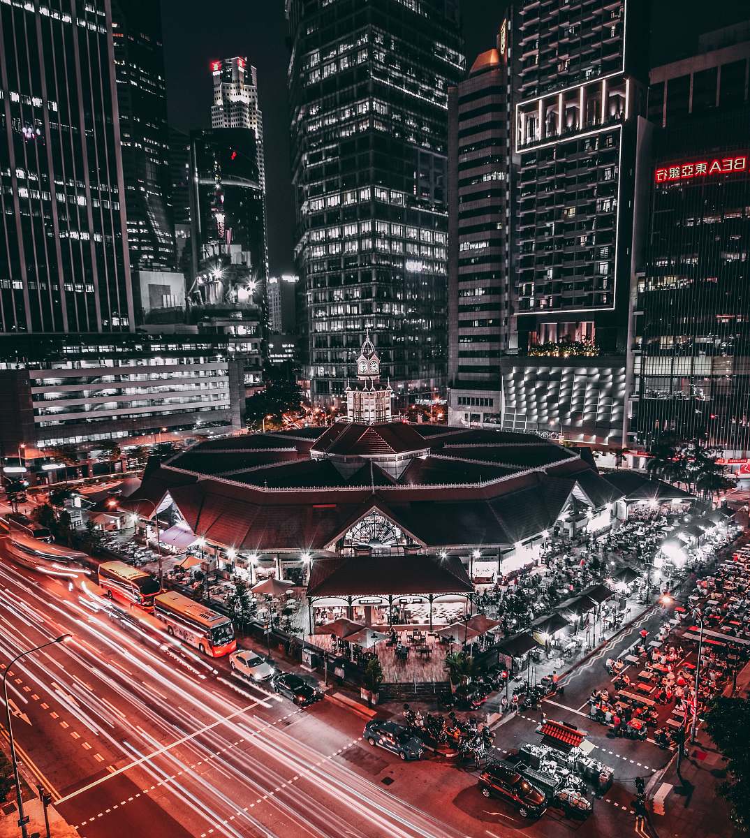 arena black and white lighted building surrounded by vehicles city