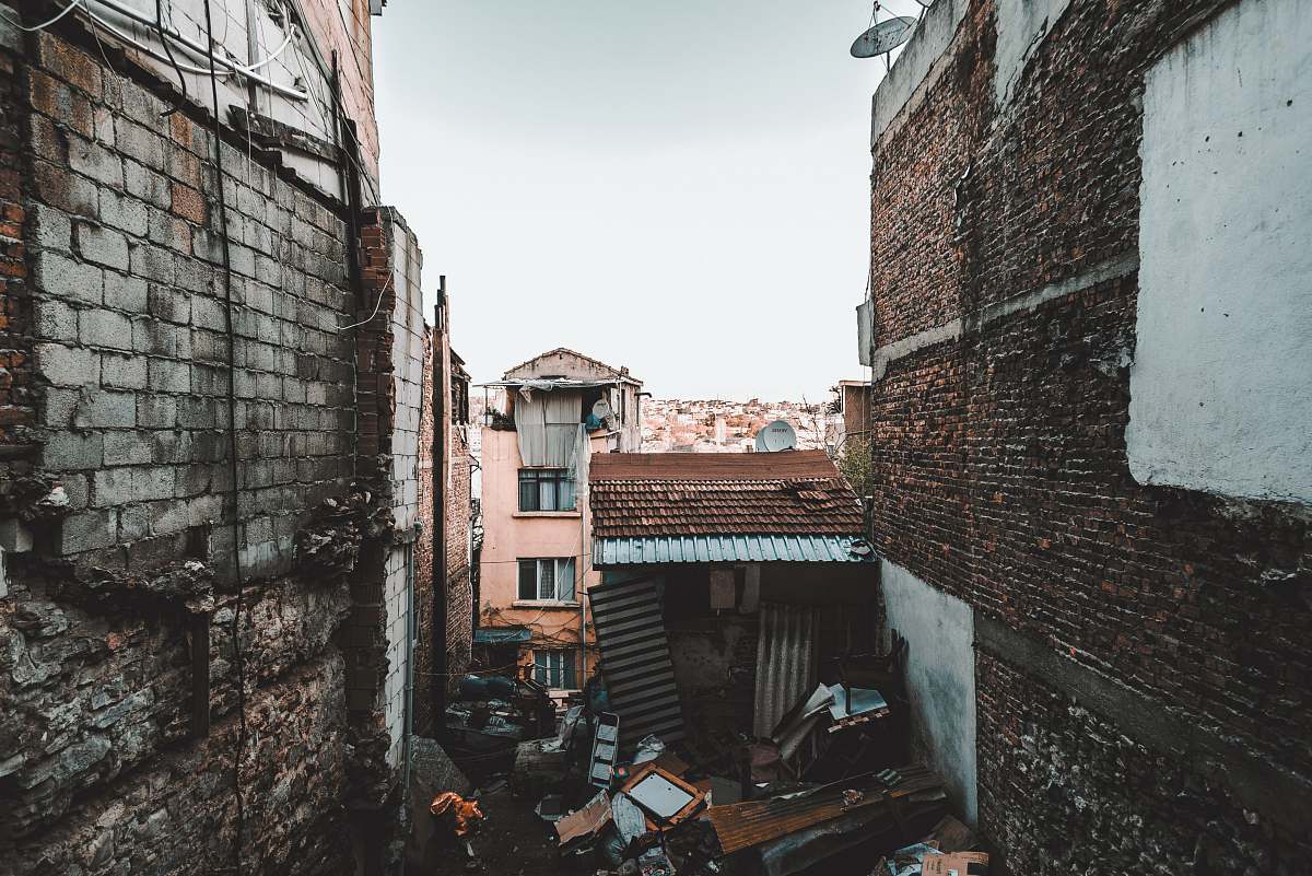city brown shed between buildings brick