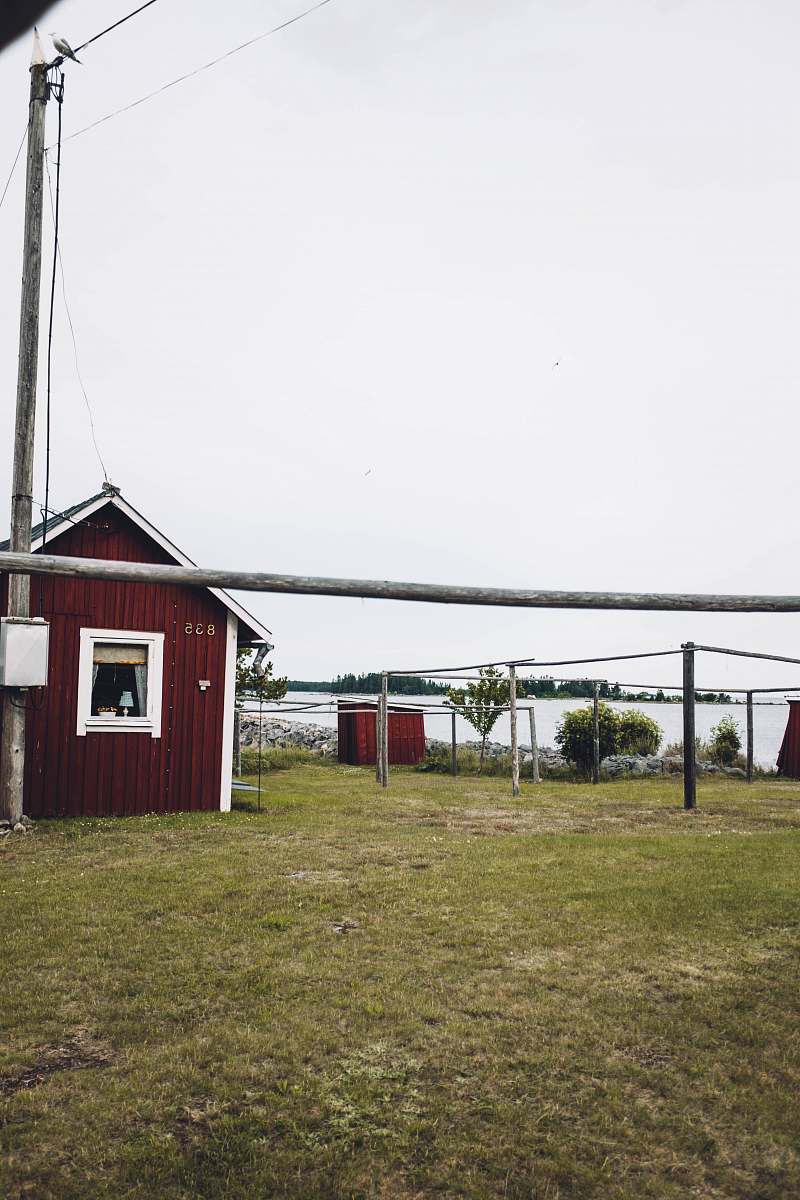 countryside brown wooden shed near utility post under white sky hut