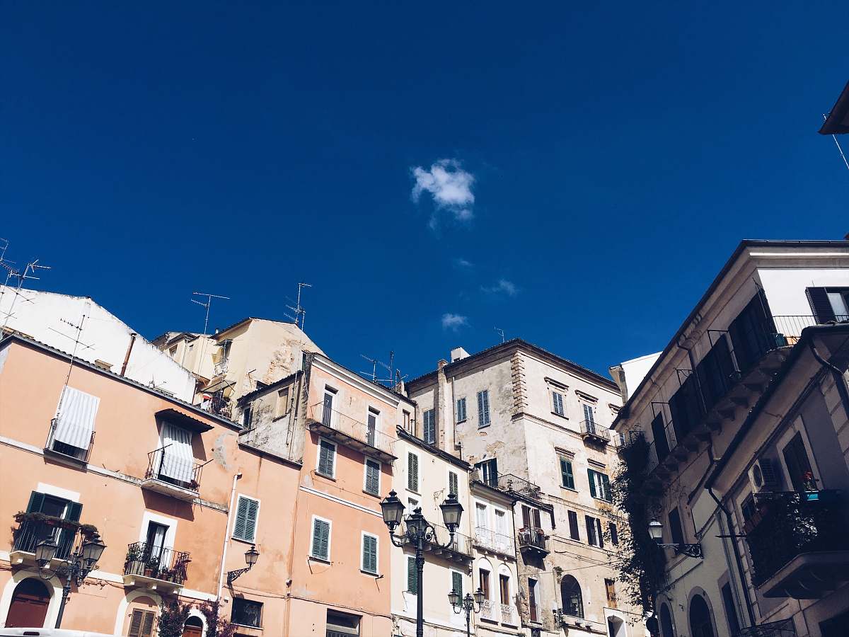 city grey and orange buildings under blue sky apartment building