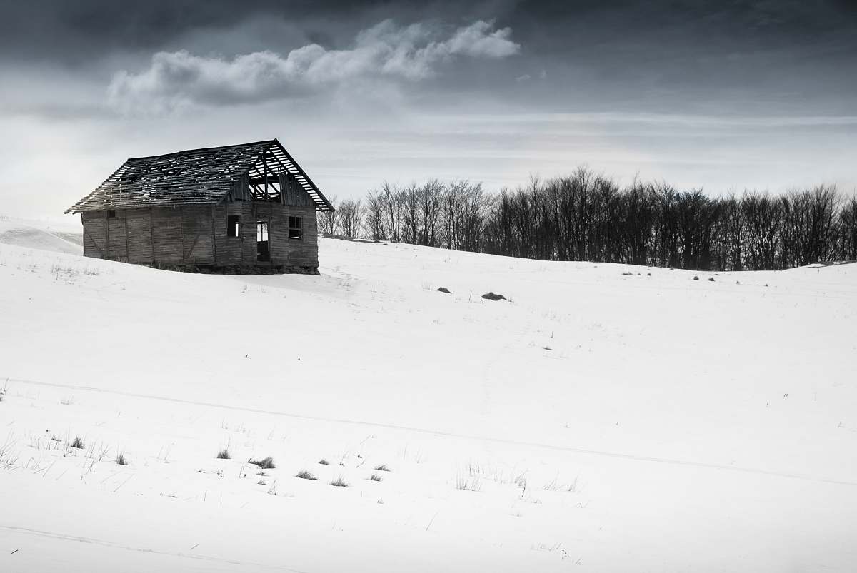 outdoors house on white snow field hut