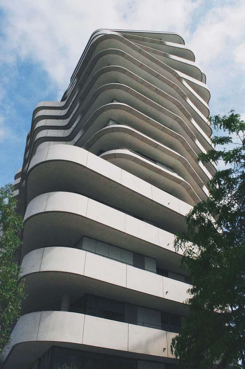 grey low-angle photo of high-rise building housing