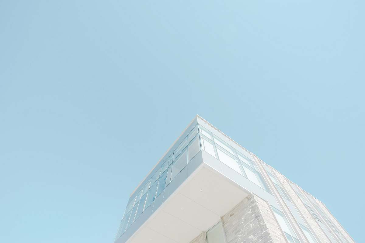 architecture low angle photograph of white concrete building blue