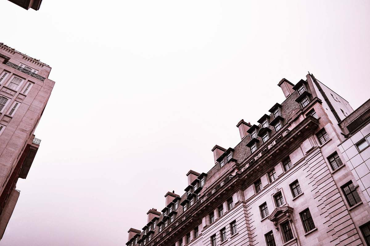 city low-angle photography of a concrete multi-storey building under a clear sky high rise