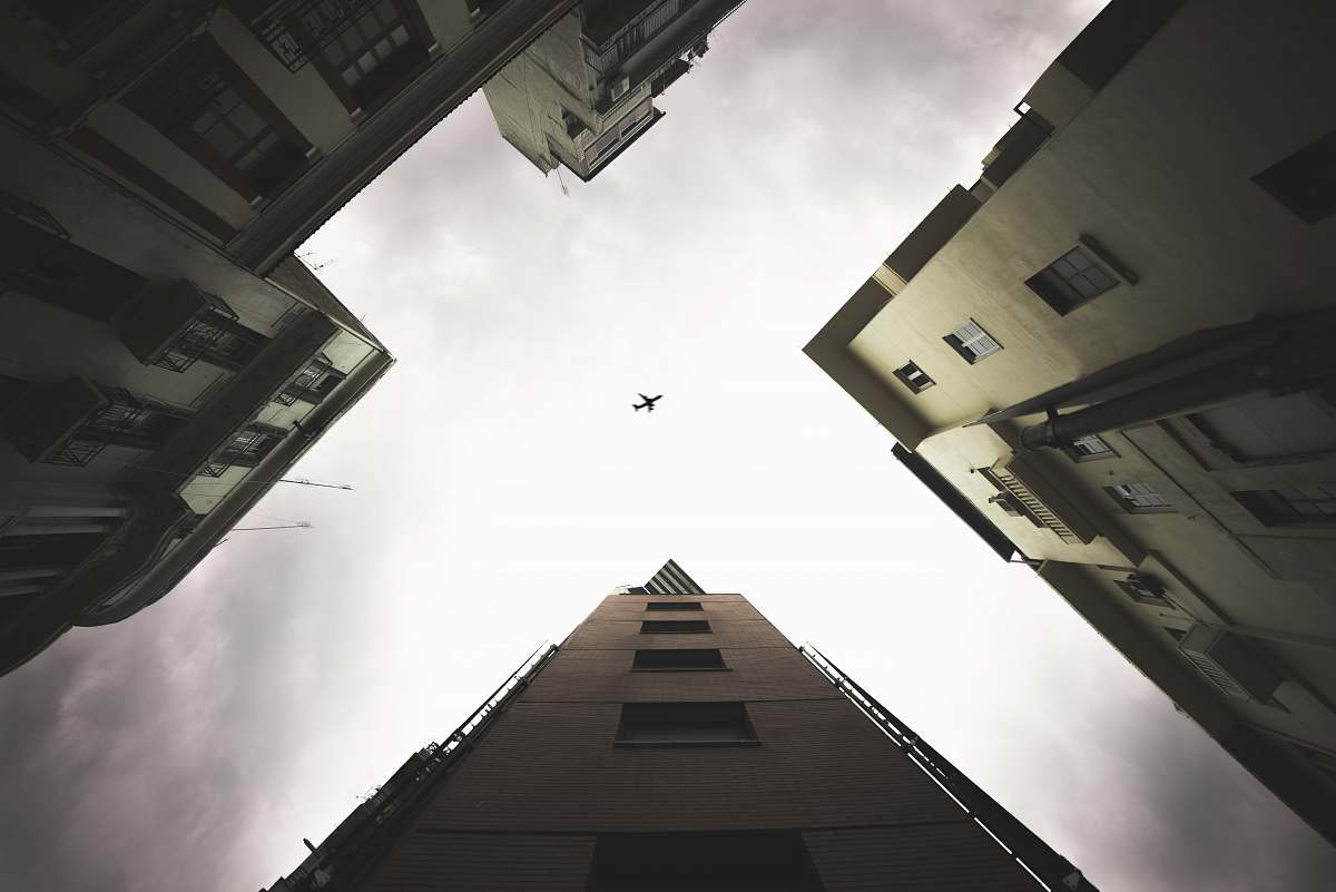 architecture low-angle photography of airplane during daytime city