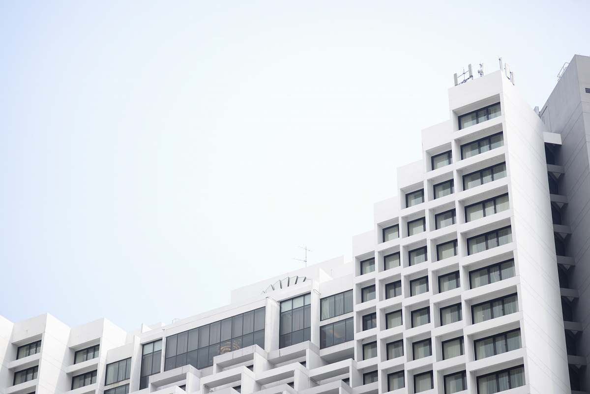 white low angle photography of white concrete building building complex