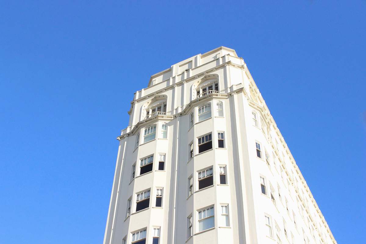 sky low-angle photography of white concrete high-rise building housing