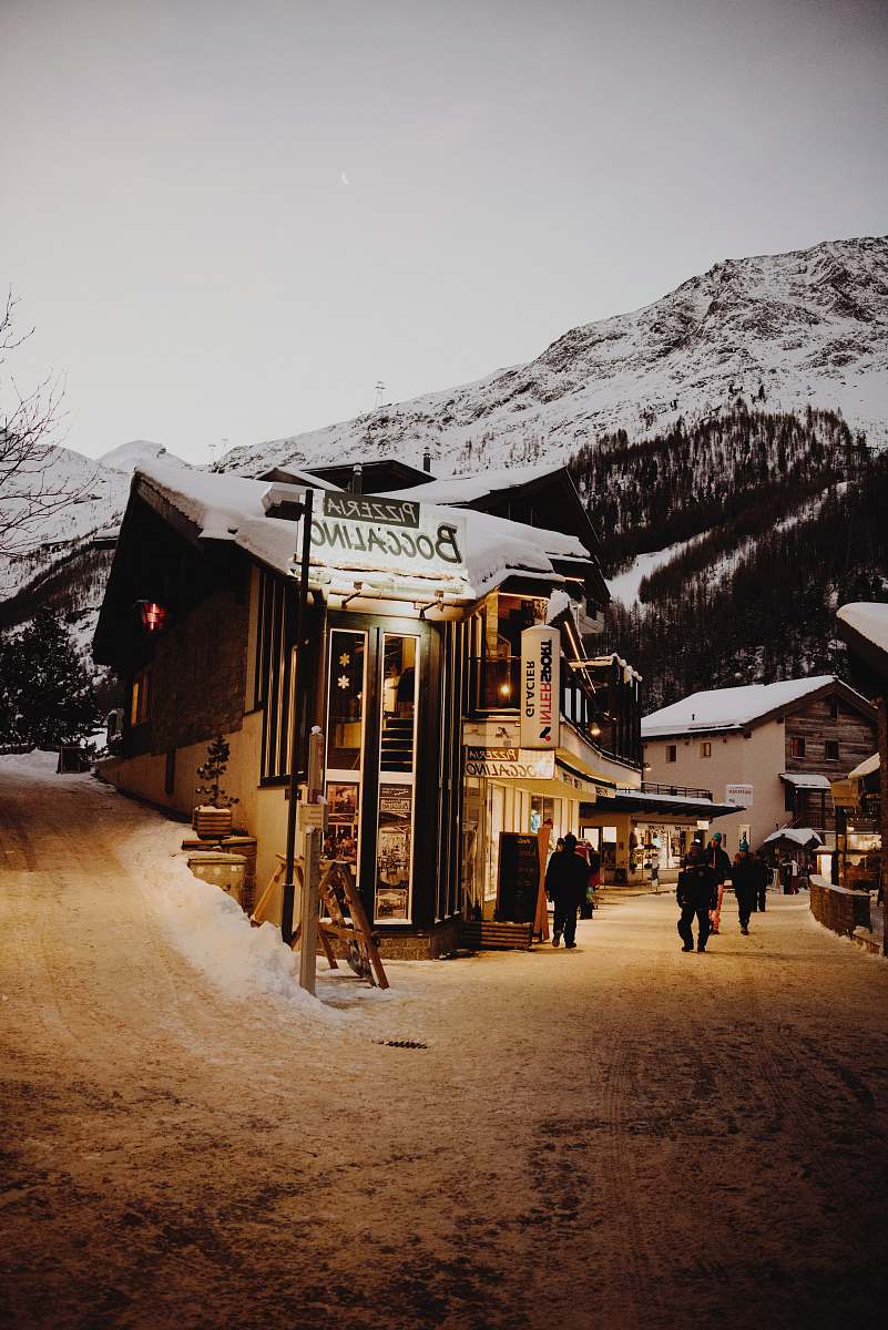 switzerland people walking beside buildings near mountain hut