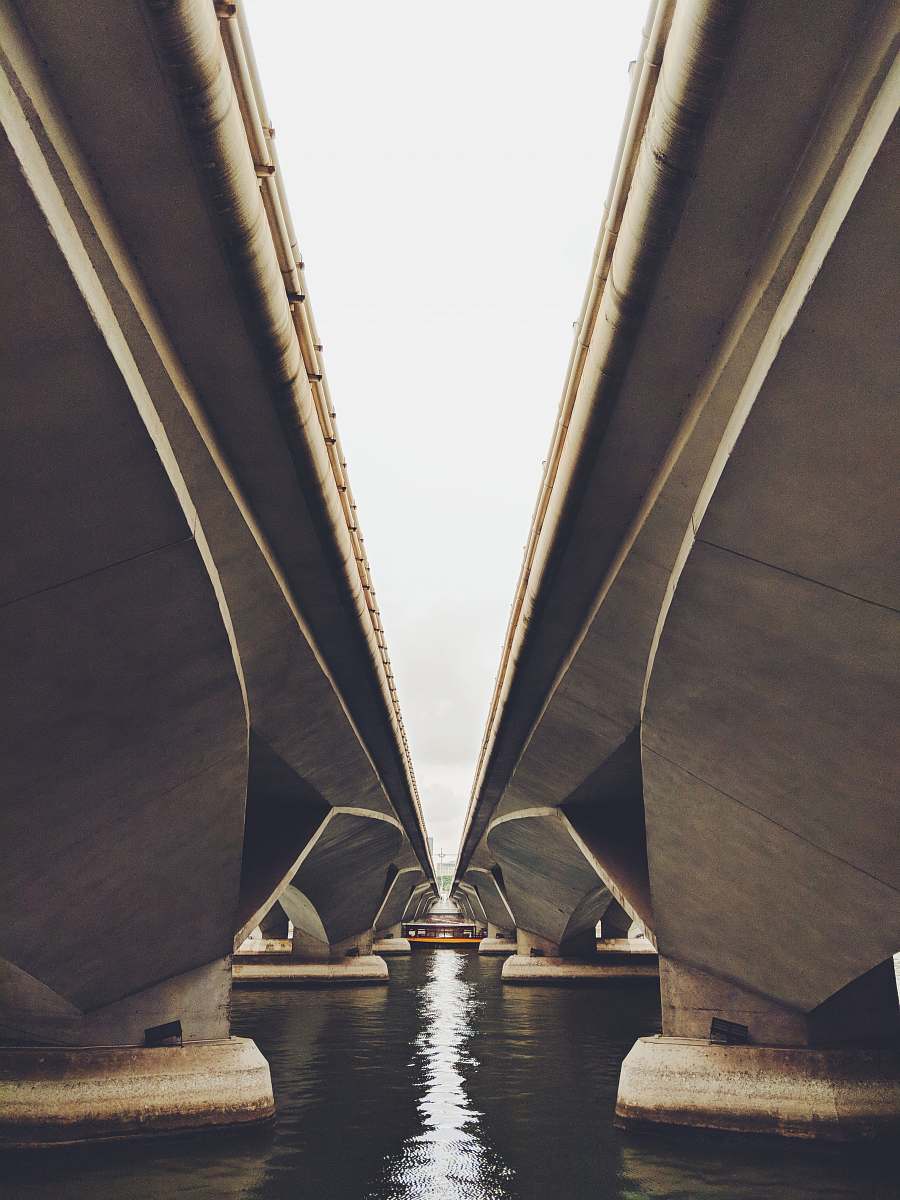 architecture two gray concrete bridge on body of water singapore