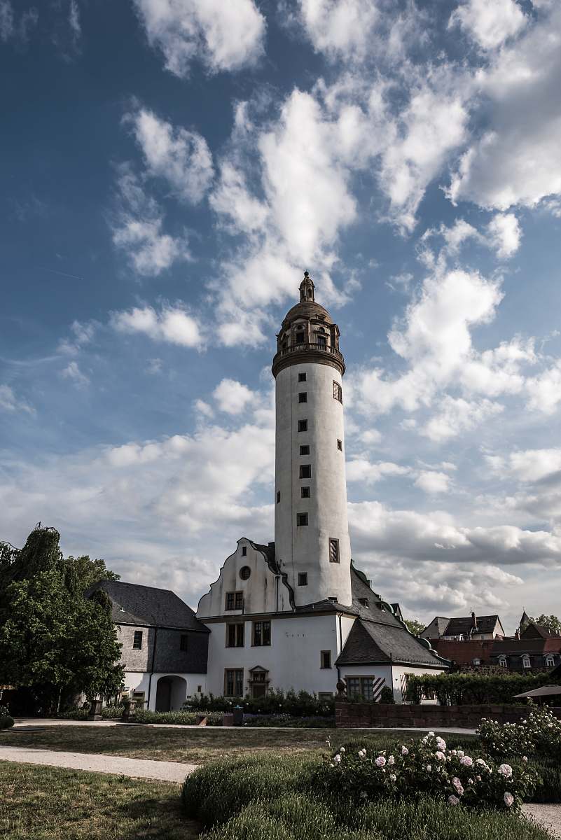 lighthouse white and brown cathedral under blue and white skies tower
