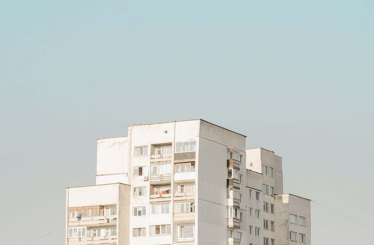urban white concrete building during daytime apartment building