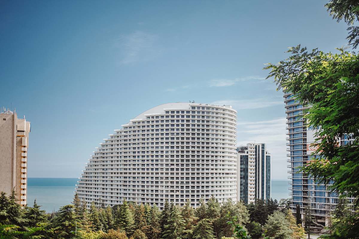 tree white concrete building under blue sky concept office building
